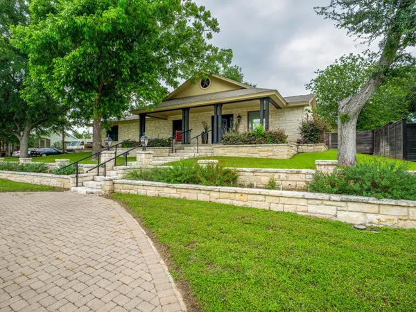 a front view of a house with a yard and porch