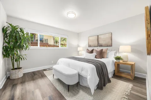 a bed room with a bed and a potted plant