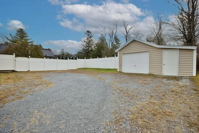 a view of an house with backyard and trees