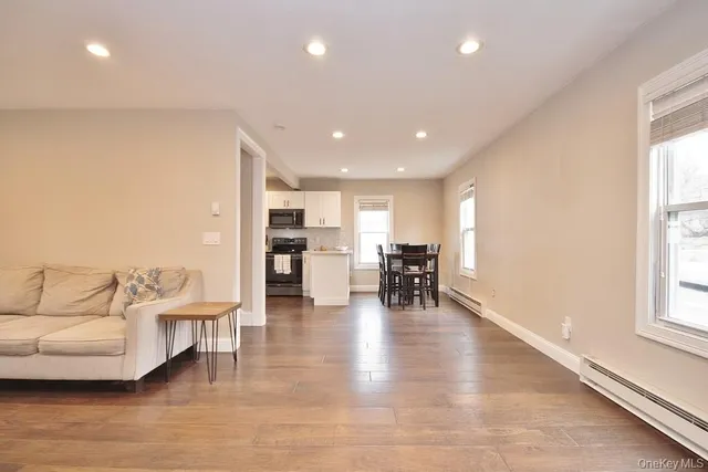 a view of kitchen with furniture and wooden floor