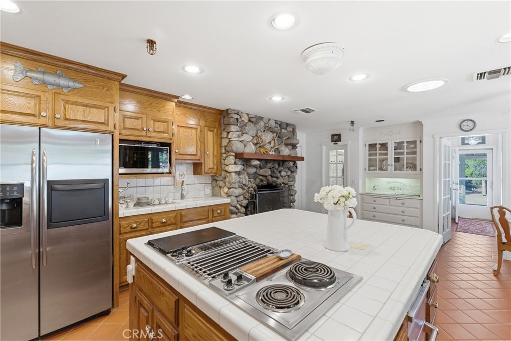 9130 Old Stage Road Agua Dulce, CA 91390 - Photo 22 of 74 a kitchen with kitchen island a counter top space a sink stainless steel appliances and cabinets