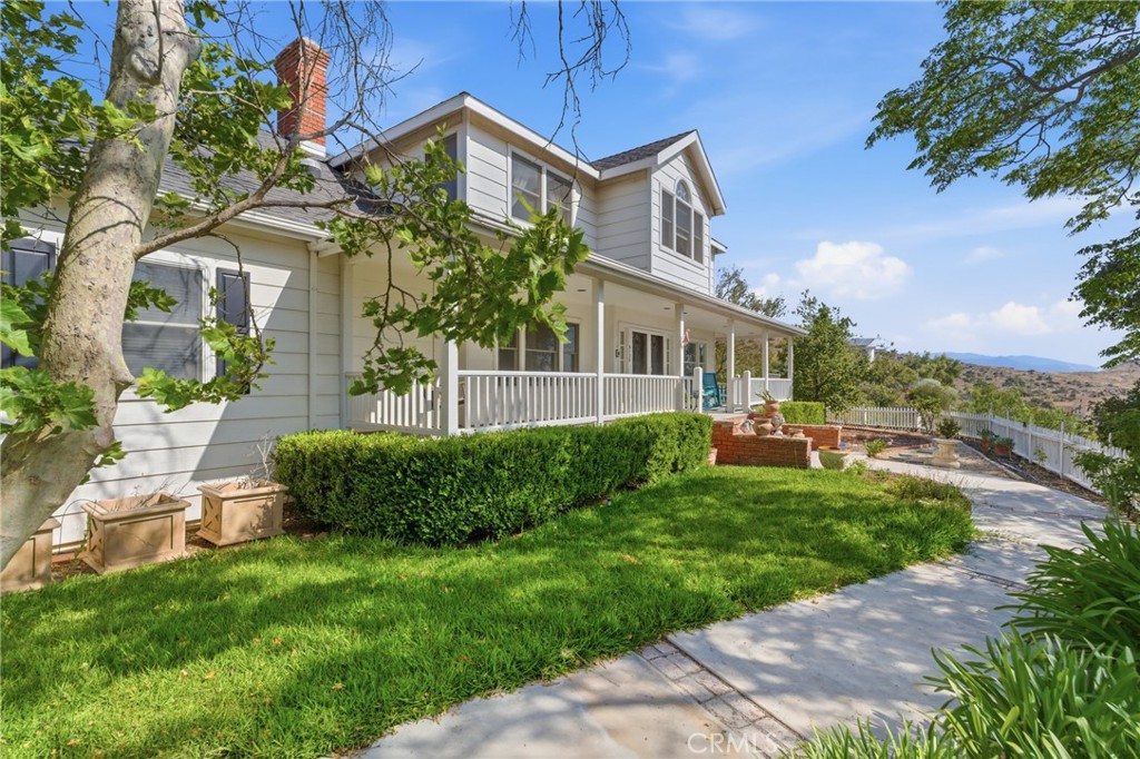 9130 Old Stage Road Agua Dulce, CA 91390 - Photo 3 of 74 a front view of a house with a garden