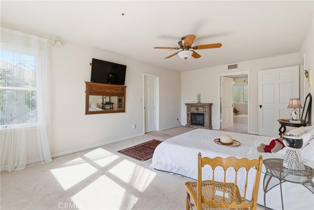 9130 Old Stage Road Agua Dulce, CA 91390 - Photo 41 of 74 a bedroom with a bed and a chandelier