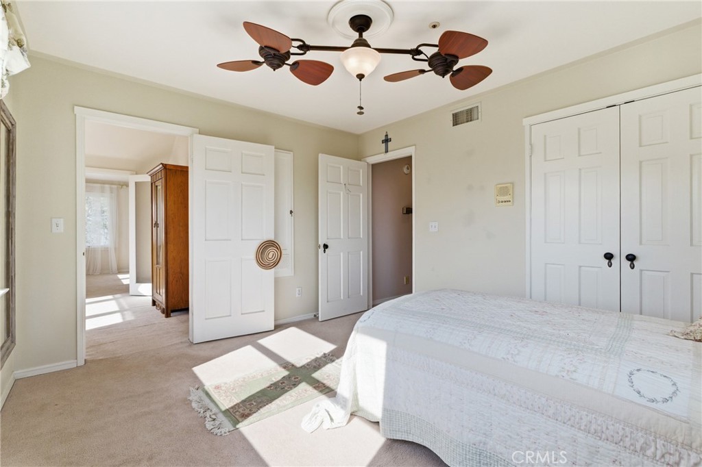 9130 Old Stage Road Agua Dulce, CA 91390 - Photo 49 of 74 a bedroom with a bed and a chandelier