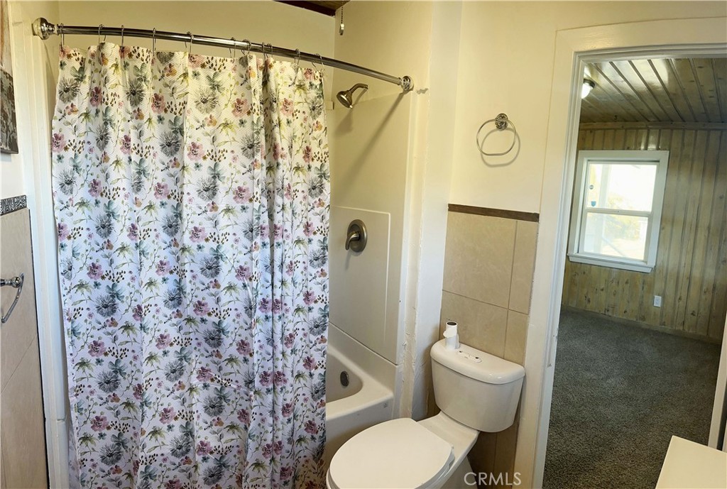 505 North Drive Lebec, CA 93243 - Photo 21 of 34 a bathroom with a toilet and a shower curtain