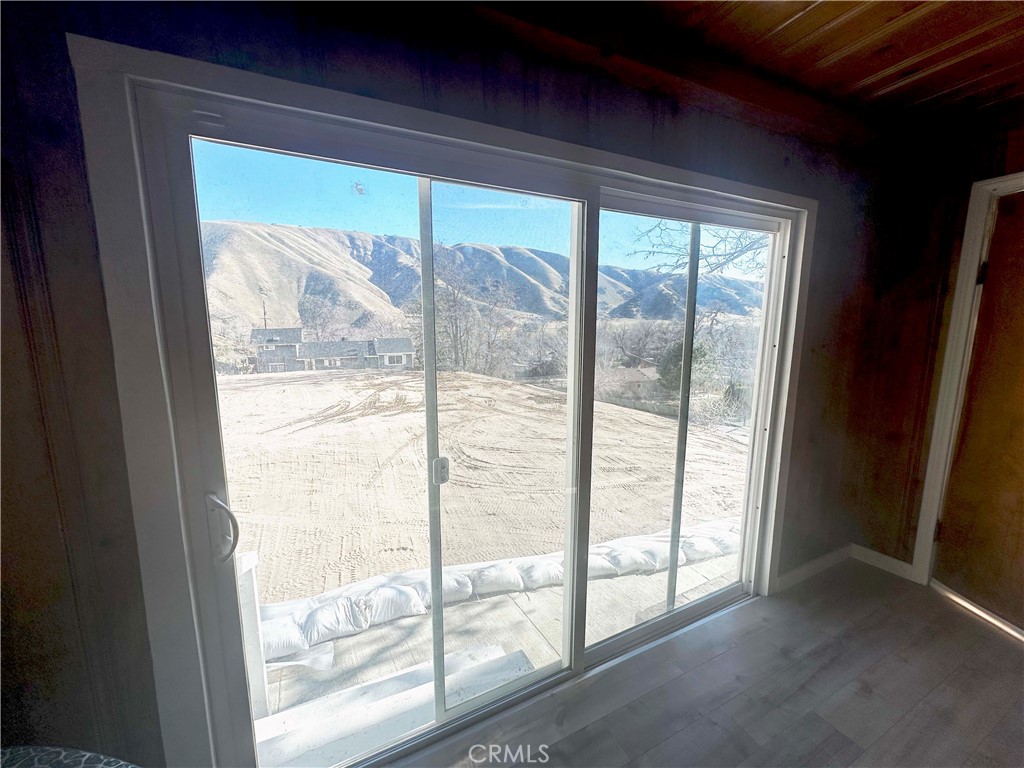 505 North Drive Lebec, CA 93243 - Photo 26 of 34 a view of an empty room with wooden floor and a window