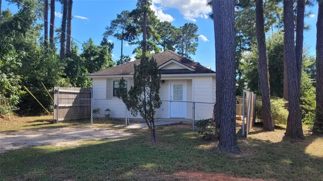 a house that has a tree in front of the house
