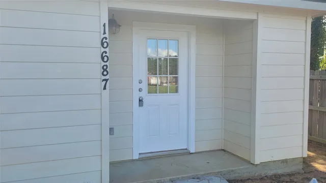 an empty room with windows and chandelier