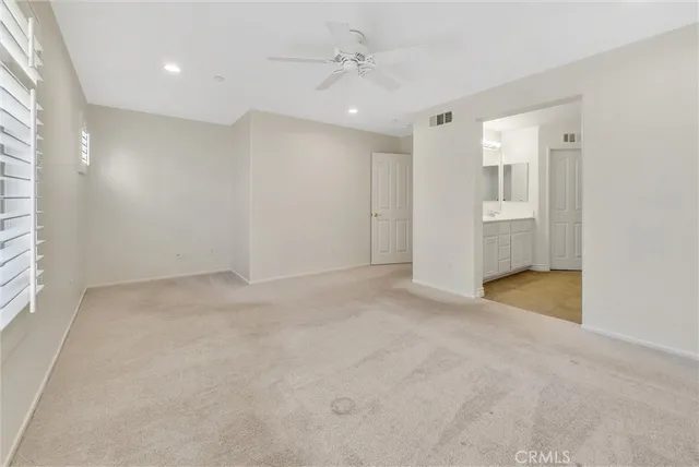 an empty room with a bathroom and a shower