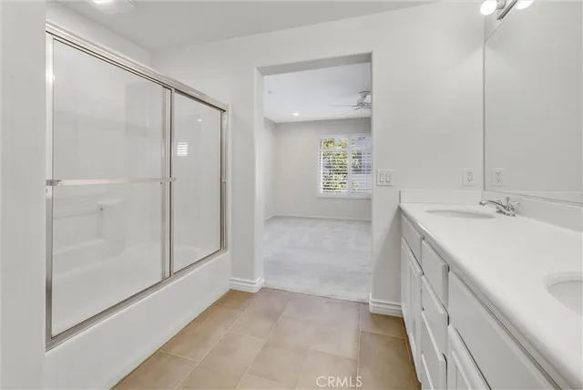 a bathroom with a sink a mirror and a shower