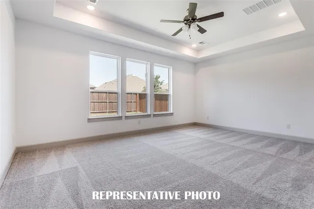 a view of a living room and kitchen with furniture wooden floor and a floor to ceiling window