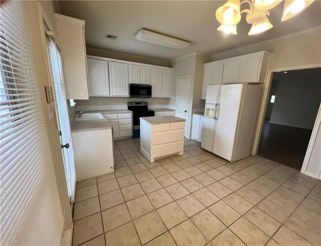 a kitchen with a refrigerator and a sink