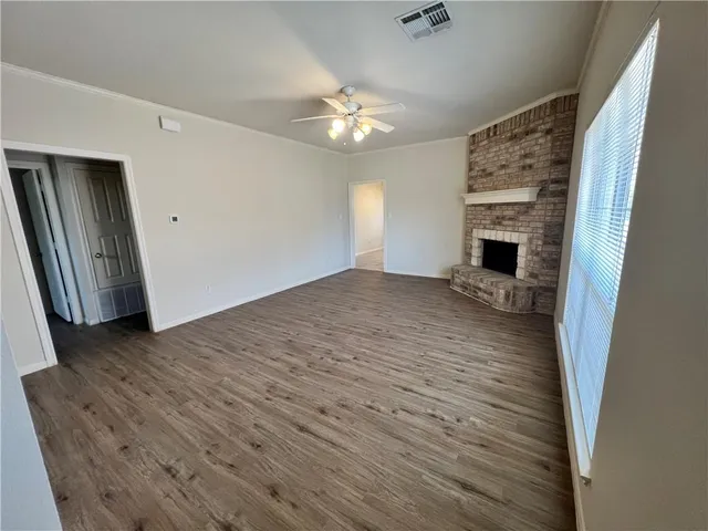 wooden floor in an empty room with a fireplace