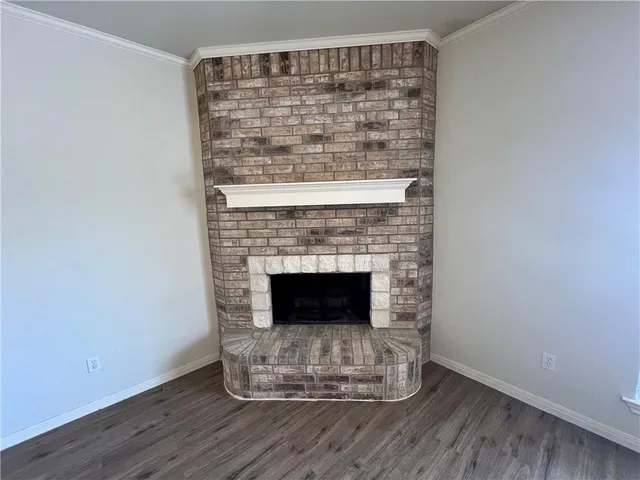 a room with a fireplace and wooden floor