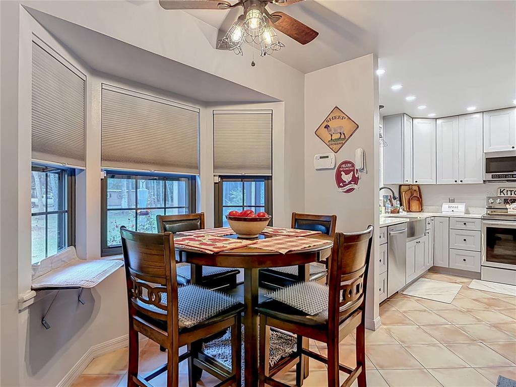 1395 Maytown Road Osteen, FL 32764 - Photo 28 of 65 a view of a dining room with furniture and chandelier