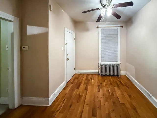 a view of a hallway with a wooden cabinet