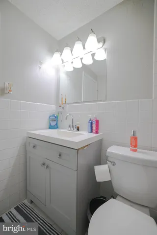 a bathroom with a sink mirror and toilet