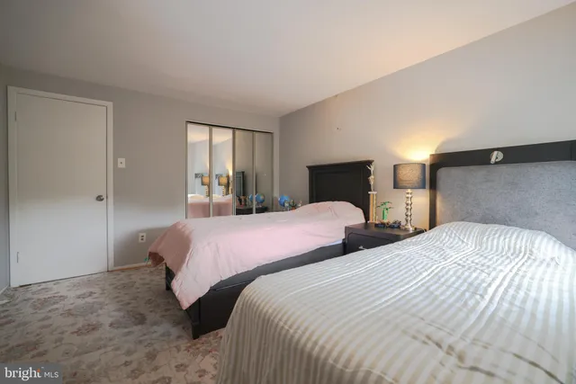 a bedroom with two beds and a window