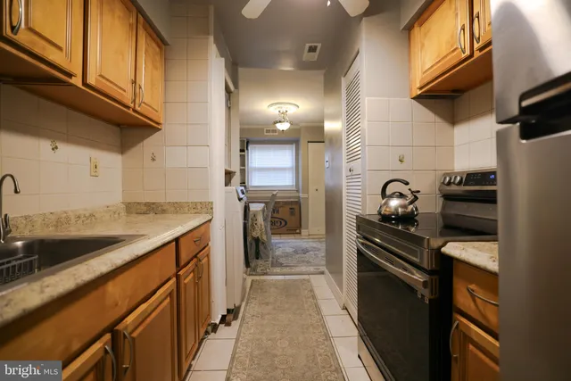 a kitchen with a sink cabinets and stainless steel appliances