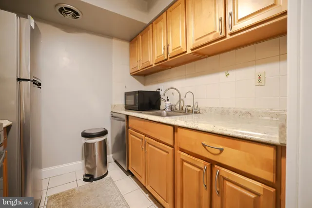 a kitchen with stainless steel appliances granite countertop a sink and cabinets