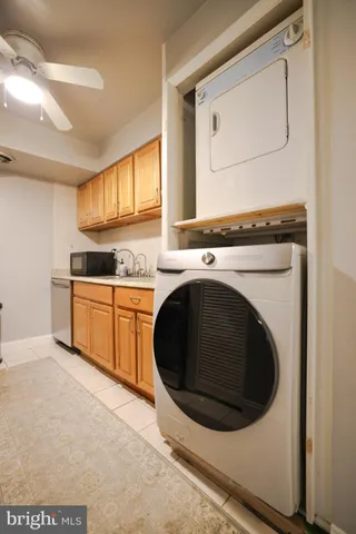 a utility room with sink dryer and washer