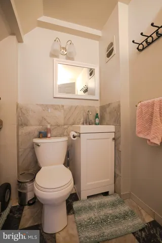 a bathroom with a toilet sink and mirror