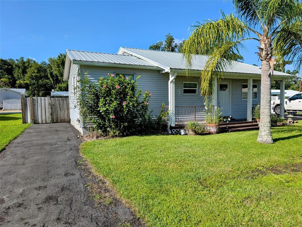 a view of a house with a yard and plants