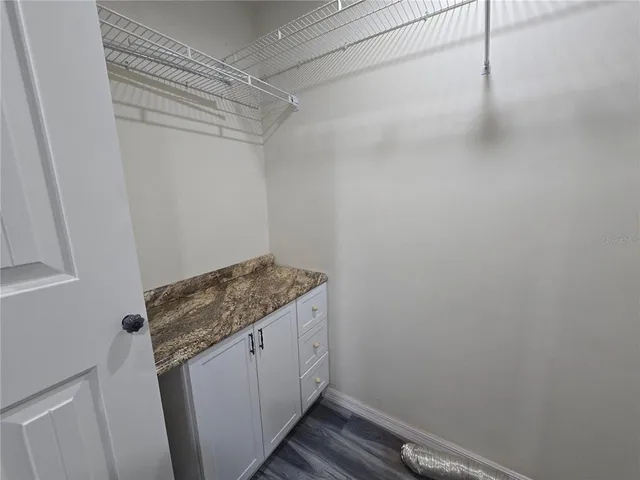 a bathroom with a double vanity sink a toilet a mirror and shower