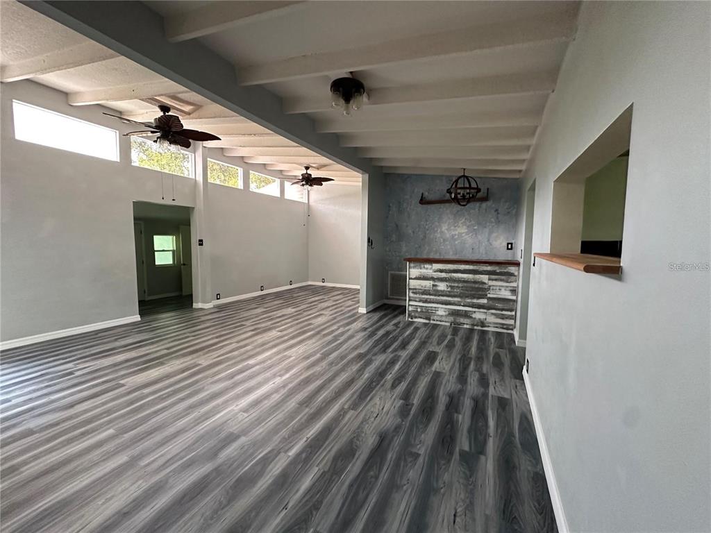 24514 Snail Road Astor, FL 32102 - Photo 4 of 8 a view of a hallway with wooden floor