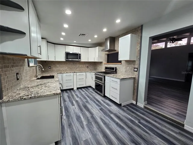a kitchen with stainless steel appliances a stove and a refrigerator