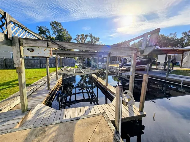 a view of a patio with table and chairs potted plants with wooden floor