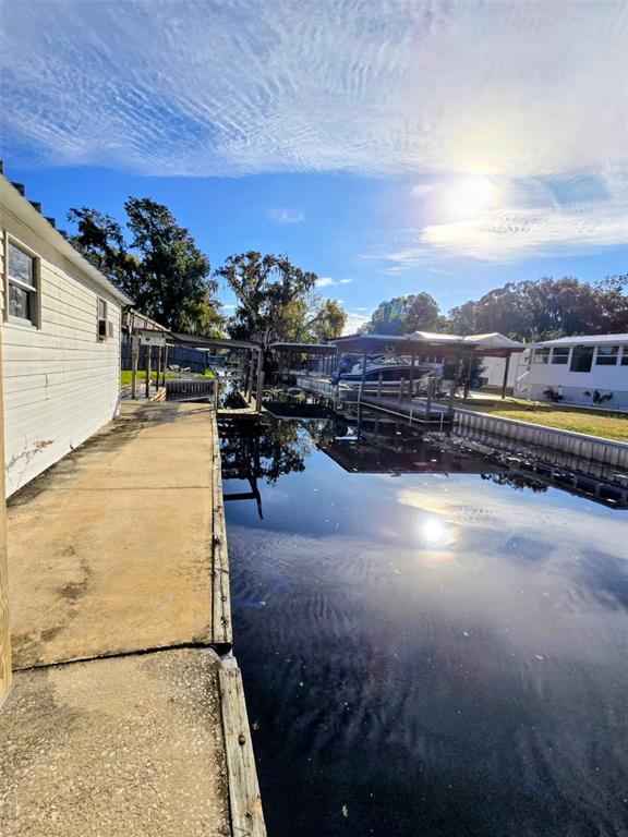 24514 Snail Road Astor, FL 32102 - Photo 8 of 8 a view of a swimming pool with a table and chairs