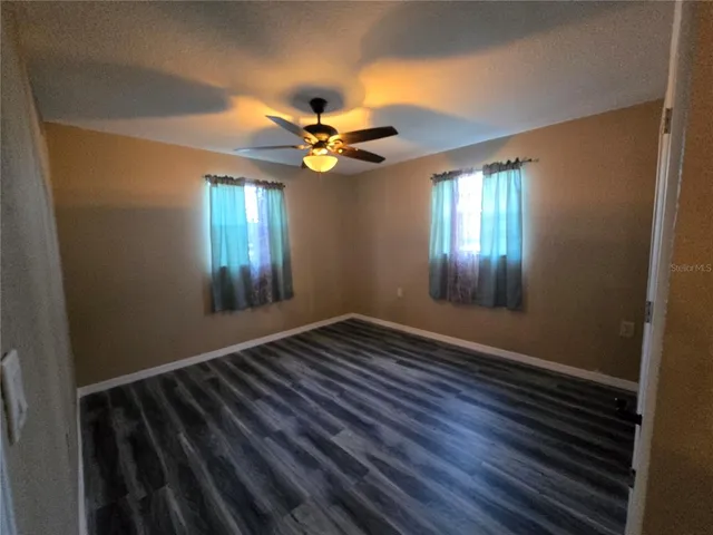 a view of room with wooden floor and staircase