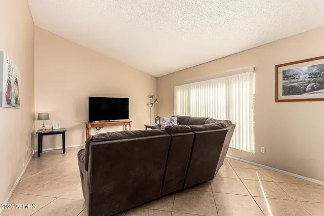 a living room with furniture a dining table and a fireplace