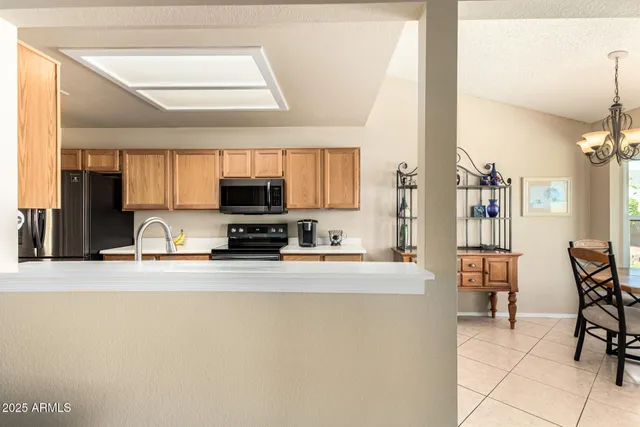 a view of a bedroom with a bed and wooden floor