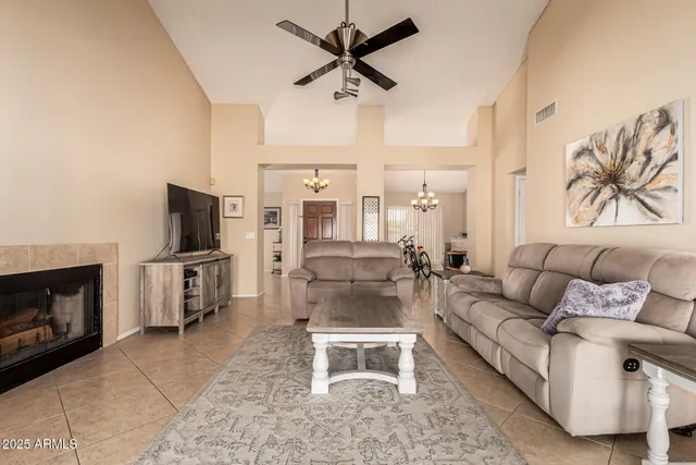 a living room with furniture a flat screen tv and a fireplace