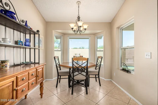 a view of a dining room with furniture and a window