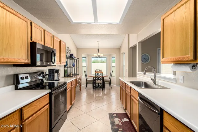 a kitchen with stainless steel appliances a sink a stove and a microwave