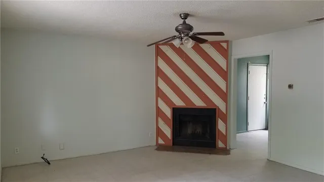 a view of empty room with fireplace
