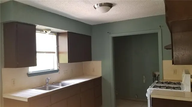 a kitchen with a sink and a window