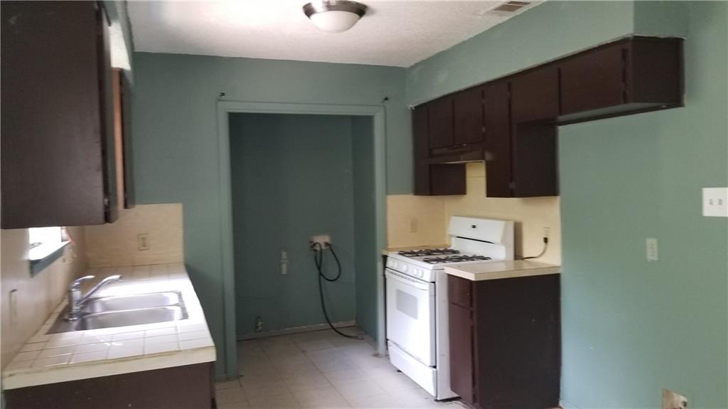 6207 Adalee Avenue, Unit B Austin, TX 78723 - Photo 6 of 11 a bathroom with a sink a toilet and mirror