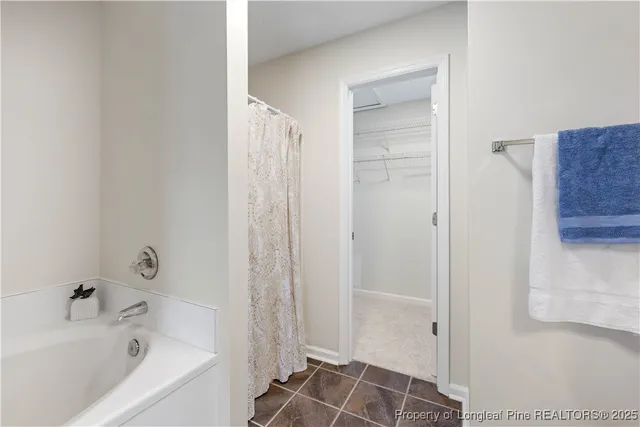 a view of a bedroom with wooden floor and windows