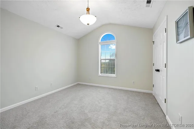 a bathroom with a granite countertop sink a toilet and a mirror