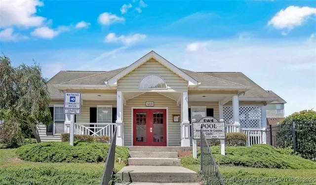 a view of a house with a deck and furniture