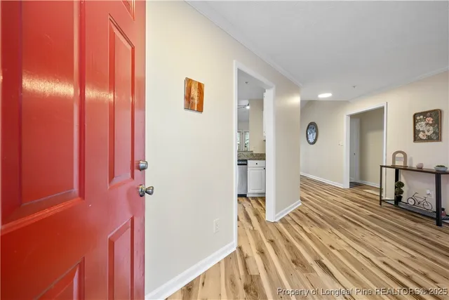 a view of a bedroom with wooden floor and stairs