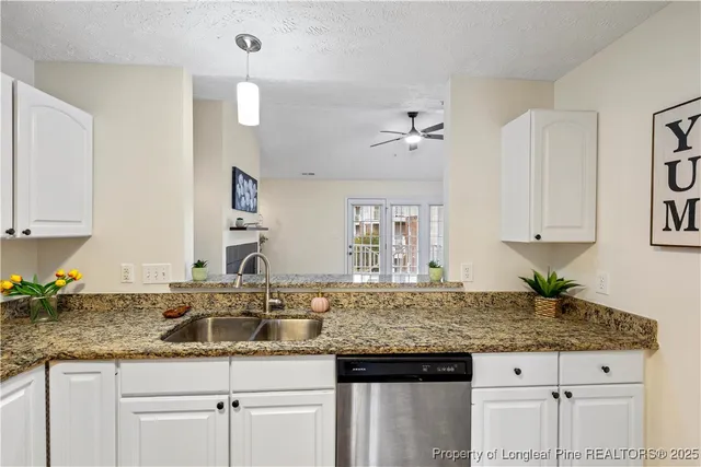 a kitchen with a sink a counter and cabinets