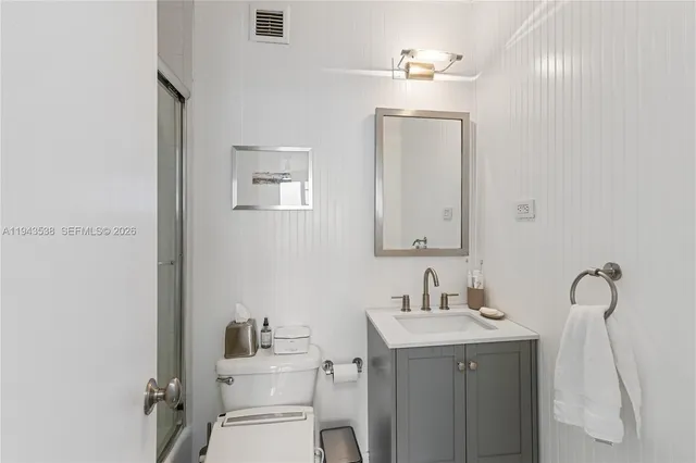 a bedroom with two beds and large windows