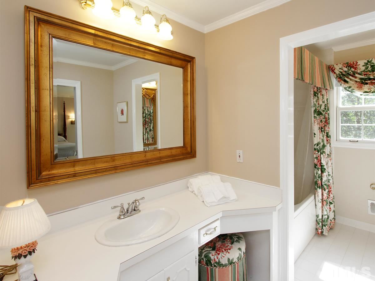 401 Sampson Street Raleigh, NC 27609 - Photo 14 of 25 a en suite bathroom with a sink and a mirror
