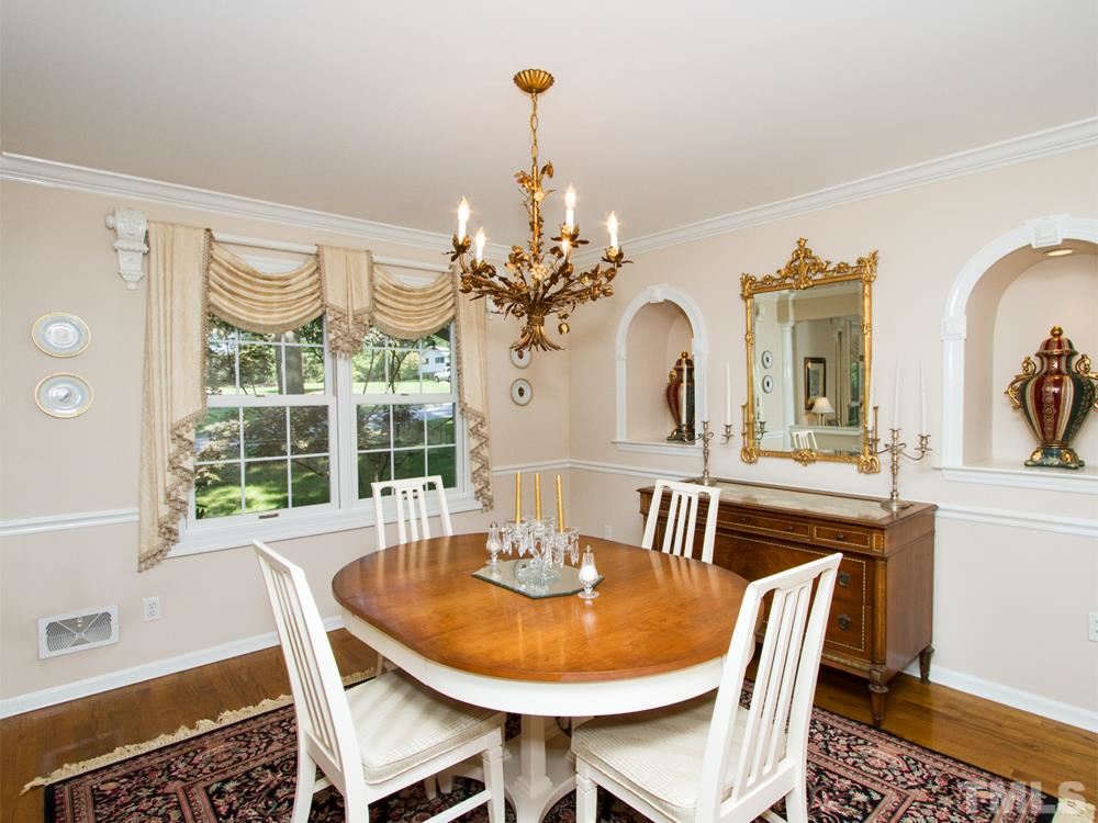 401 Sampson Street Raleigh, NC 27609 - Photo 6 of 25 a view of a dining room with furniture and chandelier