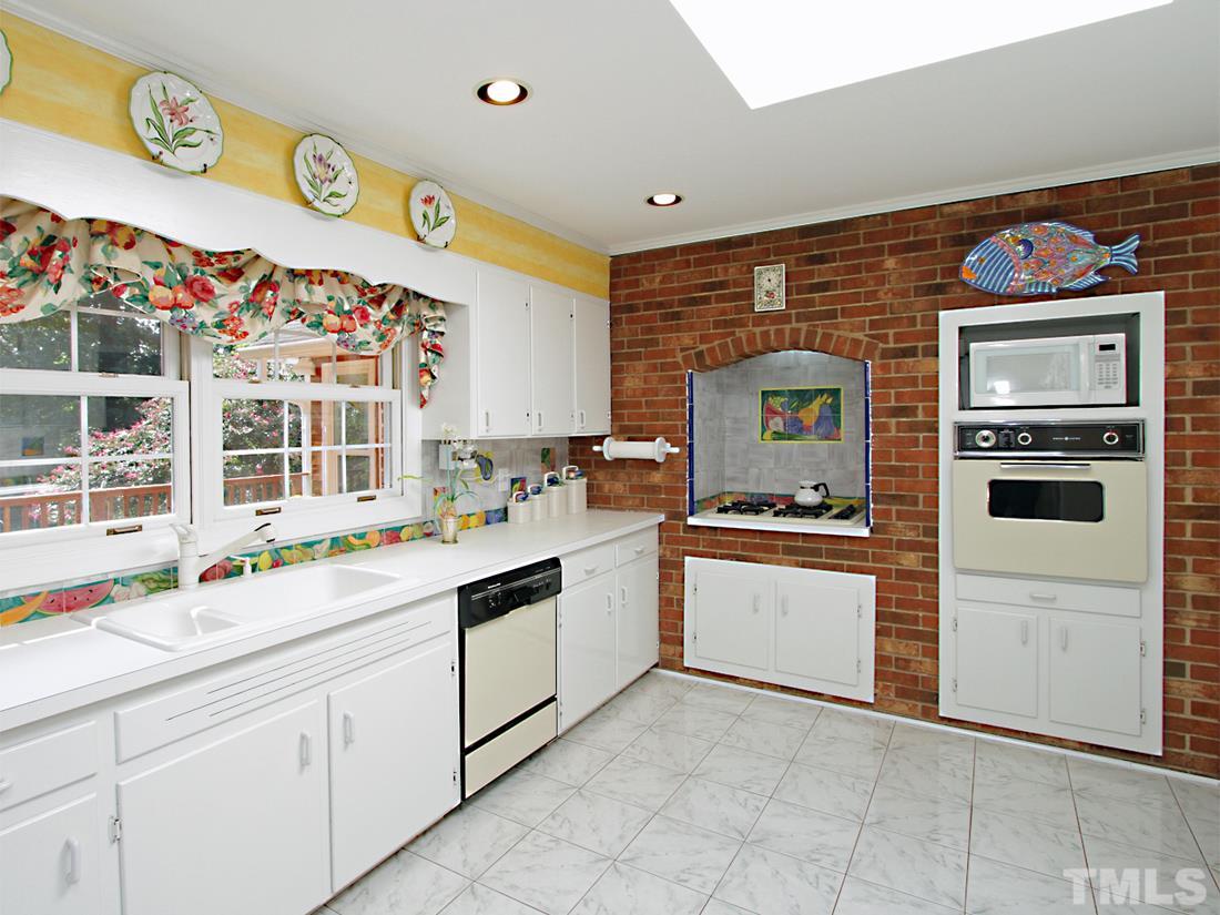 401 Sampson Street Raleigh, NC 27609 - Photo 10 of 25 a kitchen with a sink and a stove top oven